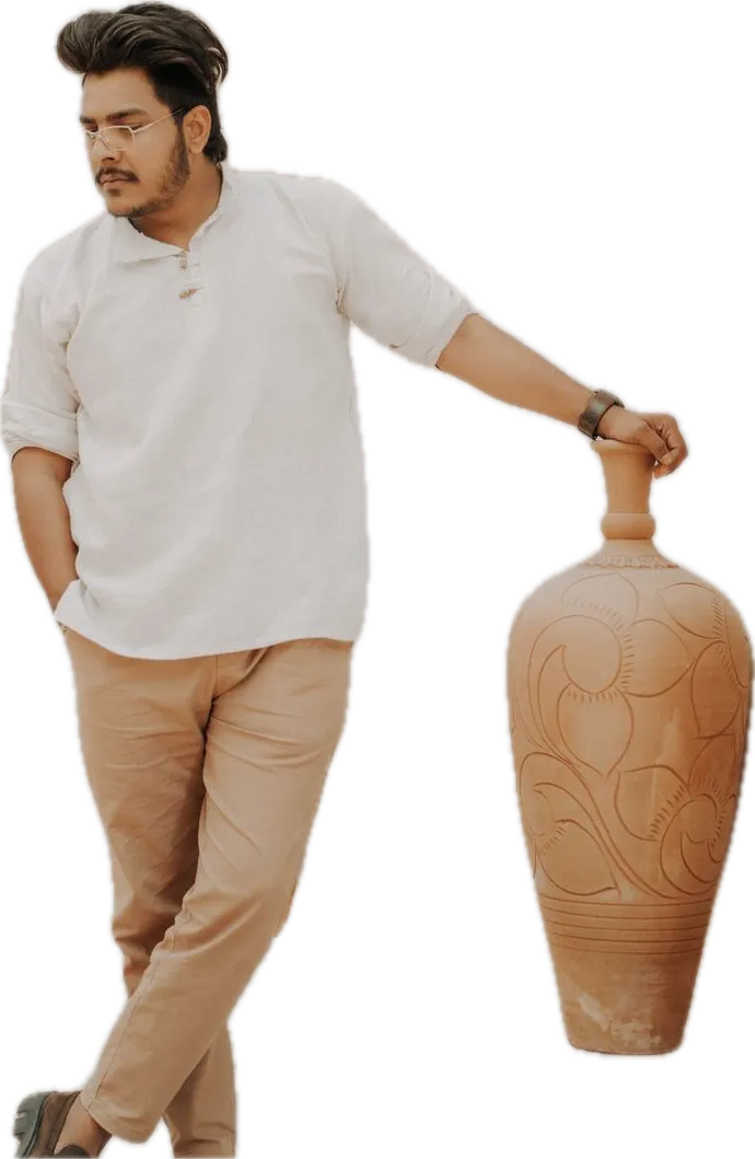 Stone peached twill chinos with a white half-sleeve top, beside a clay vase